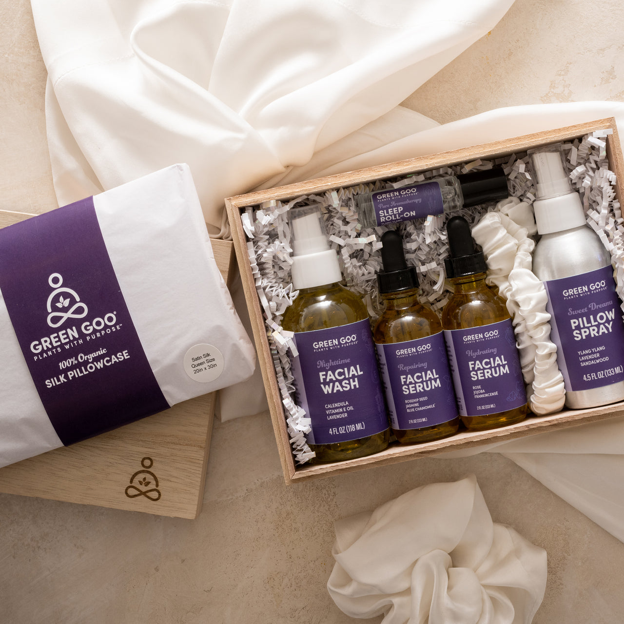 Green Goo's Sierra Sage Sleep Secrets Gift Set includes an embossed wooden collector's box, oil-based facial wash, pillow spray, two facial serums, a sleep roll-on, and exclusive, organic silk queen-sized pillowcase, scrunchie, and headband produced by The Silk Lady.