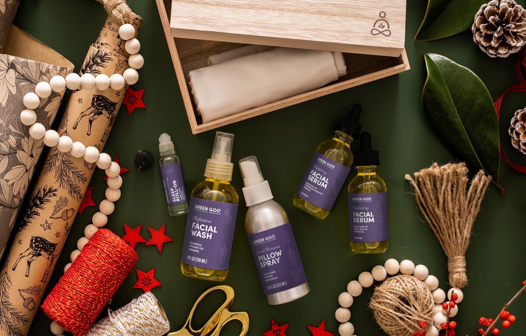 Green Goo's Sierra Sage Sleep Secrets Gift Set includes two facial serums, facial wash, sleep roll-on, pillow spray, and exclusive silk pillowcase, headband, and scrunchie from The Silk Lady in a high-end, GooRu enblazoned wooden box.